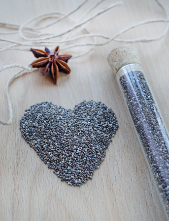 Chia seeds on wooden cutting board. Closeup photo.の写真素材