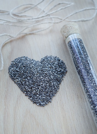 Chia seeds on wooden cutting board. Closeup photo.の写真素材