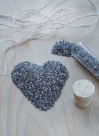 Chia seeds on wooden cutting board. Closeup photo.の写真素材