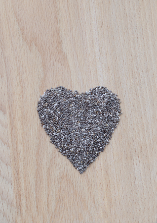 Chia seeds on wooden cutting board. Closeup photo.の写真素材