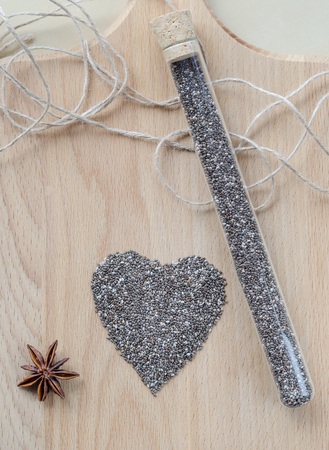 Chia seeds on wooden cutting board. Closeup photo.の写真素材