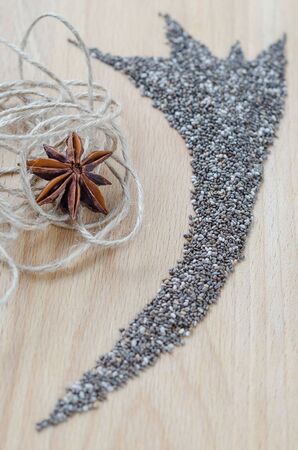 Chia seeds on wooden cutting board. Closeup photo.の写真素材