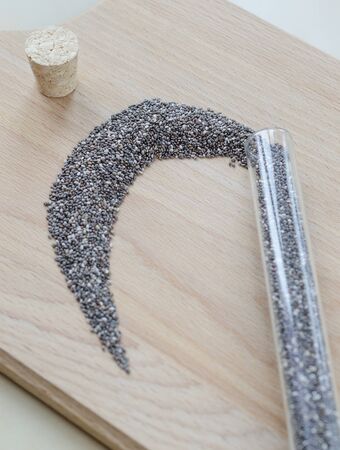 Chia seeds on wooden cutting board. Closeup photo.の写真素材