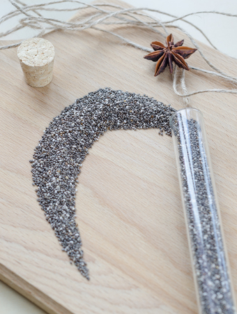 Chia seeds on wooden cutting board. Closeup photo.の写真素材