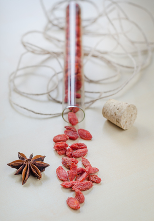 Goji berries and clove on a wooden Board. Closeupの写真素材