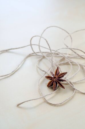Dried carnation and twine on a wooden Board closeupの写真素材