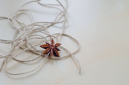 Dried carnation and twine on a wooden Board closeupの写真素材