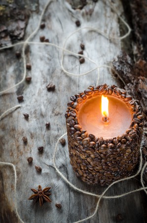 Burning aromatic coffee candle and coffee beans, close-upの写真素材