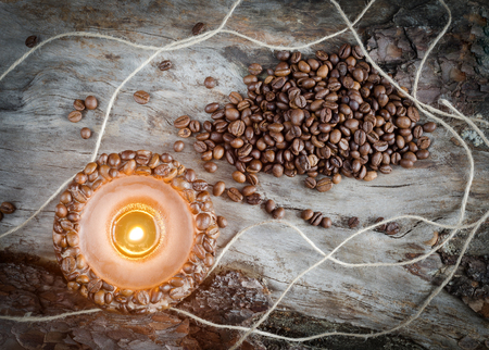 Burning aromatic coffee candle and coffee beans, close-upの写真素材