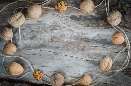Walnuts on aged wood with twine. Closeupの写真素材