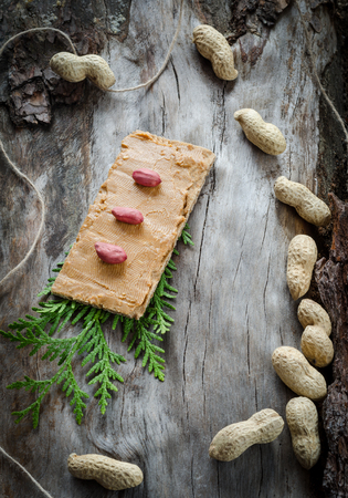 Sandwich with peanut butter on the background of old wood. Closeupの写真素材