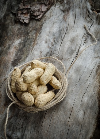 Raw peanuts scattered on aged wood. Backgroundの写真素材
