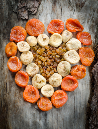 Assortment of dried figs, raisins and apricots in the form of heart. Closeupの写真素材