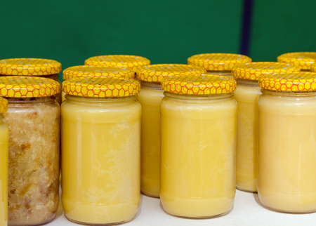 A lot of glass jars with honey closeup.の写真素材