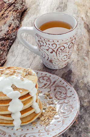 Stack of hot pancakes with oatmeal and yogurt. Closeupの写真素材