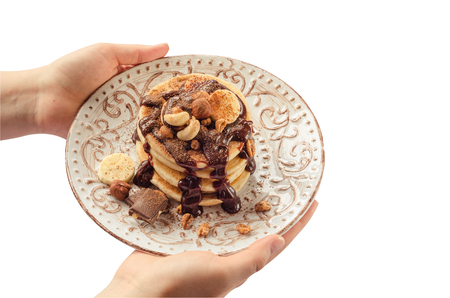 Stack of hot pancakes in woman hands. Isolated.の写真素材