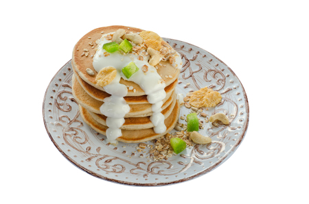 Stack of hot pancakes with oatmeal and yogurt. Isolatedの写真素材