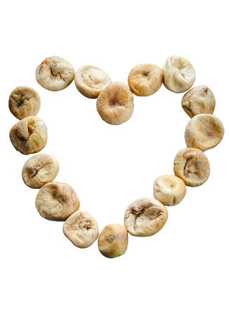 Dried figs in the form of heart isolated on white backgroundの写真素材