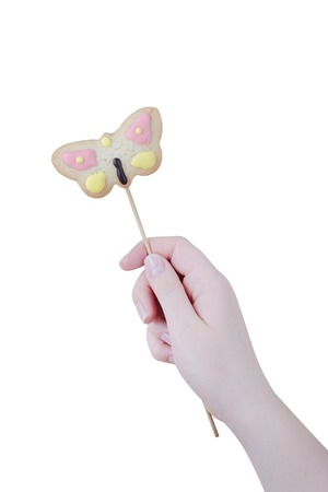 Woman's hands holding a Valentine cookie isolated on white background.の写真素材