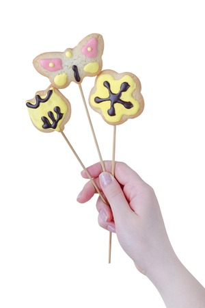 Woman's hands holding a Valentine cookies isolated on white background.の写真素材
