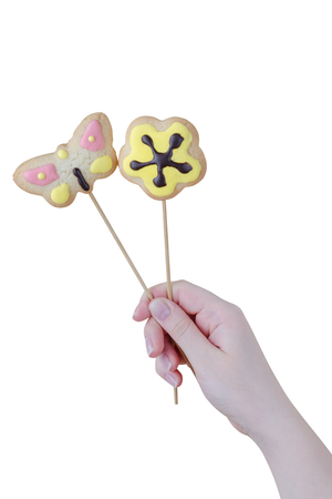 Woman's hands holding a Valentine cookies isolated on white background.の写真素材