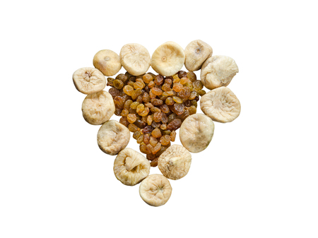 Assortment of dried figs and raisins in the form of heart isolated on white background.の写真素材