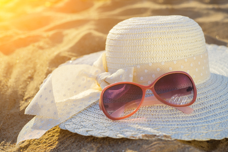 beach background with hat and glasses of redの写真素材
