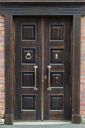 Old brass handle on vintage wood door.の写真素材