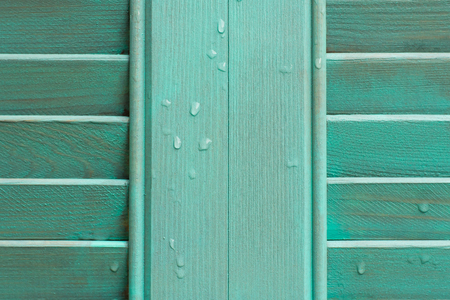 Cyan window with wooden shutter. Closeup wooden awningの写真素材