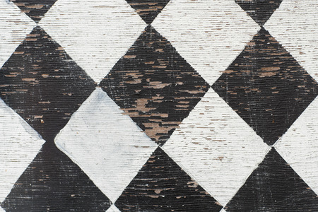 black and white tiles pattern painted on wood textureの写真素材