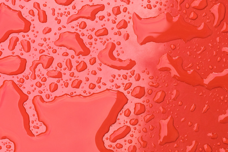 Water drops on red background. Close upの写真素材