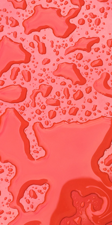Water drops on red background. Close upの写真素材