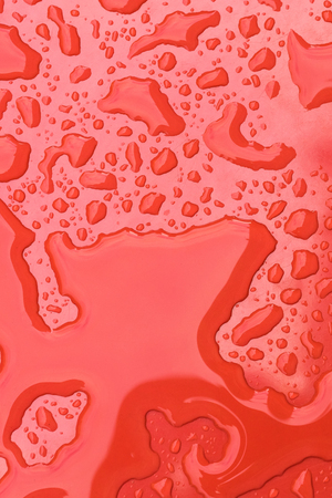 Water drops on red background. Close upの写真素材