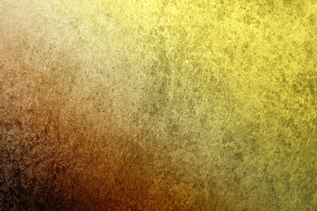 A textured vintage stucco background with a dark orange to golden yellow gradient.の写真素材