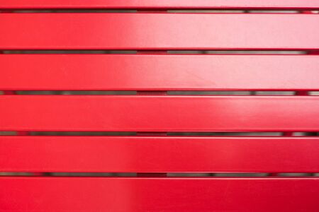 Red wooden bench close-up.の写真素材