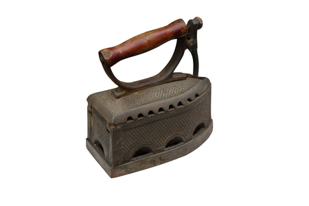 Isolated old fashioned retro metallized heavy antique iron tool for ironingの写真素材