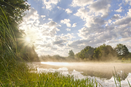 beautiful morning landscape with sunrise over river.の写真素材