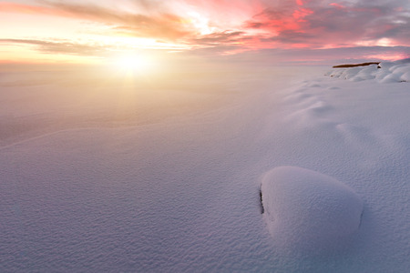 Winter sunset with snow-covered rocks. Composition of nature.の写真素材