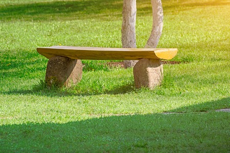 Stone bench on the front yard lawn. Landscape design.の写真素材