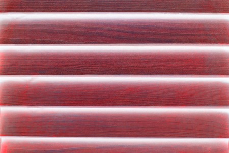 Abstract red window with wooden shutter. Closeup wooden awning.の写真素材