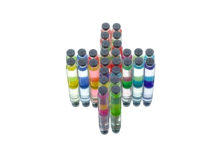 Set of laboratory flasks with a colored reagents in form medical cross, isolatedの写真素材