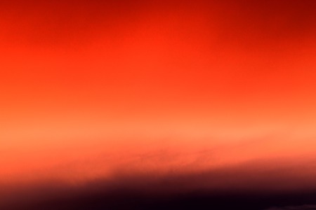 Abstract red background with bokeh defocused lightsの写真素材
