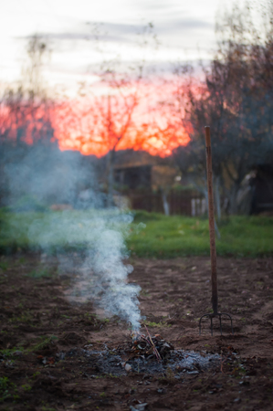 Close up of burning garden bonfire with pitchforkの写真素材