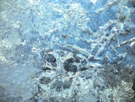 Close-up of cracked ice texture on river in spring timeの写真素材