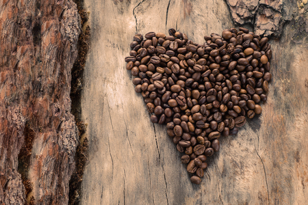 Coffee in form of heart on grunge wooden background. Top viewの写真素材