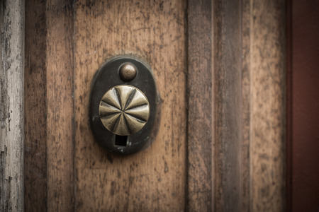 Old wooden door with round bronze handleの写真素材