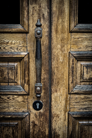 old wooden entrance door with antique door handleの写真素材