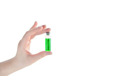 Ampoule with vaccine from a new coronavirus in a woman hand isolated on white background. Flu vaccination concept.の写真素材