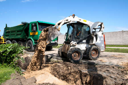 Mini Bobcat work on a street reconstruction