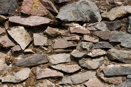 Rock Wall.Close up of a Stacked Stone Facade Background 